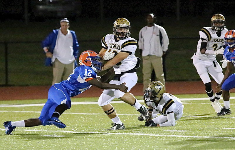 Image: Sophomore running back Hunter Merimon(9) spins his way free from a Gator tackler with blockers Levi McBride(1) and Trevon Robertson(3) trying to clear a path.