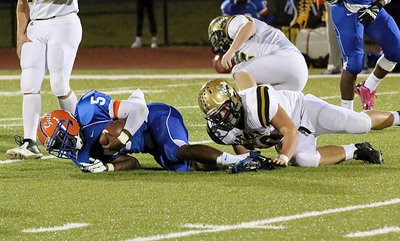 Image: Gladiator defensive end Zain Byers(50) catches a Gator from behind and for a loss in the Gateway backfield using his patented alligator roll tackling style.