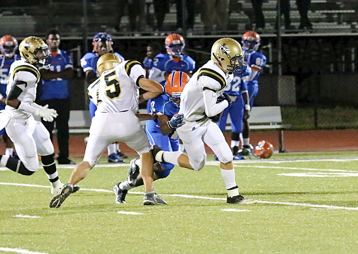 Image: Ryan Connor(7) intercepts a Gator pass as teammate Cody Medrano(75) tries to throw a block to help Connor get away for more yards on the return.