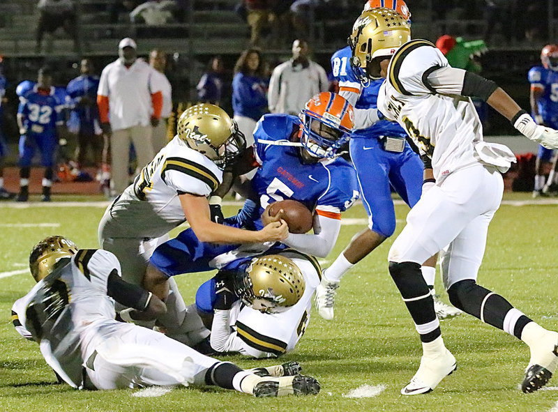 Image: Bailey Walton(54), Ryan Connor(7), TaMarcus Sheppard(10) and Trevon Robertson close in on Gateway’s running back.