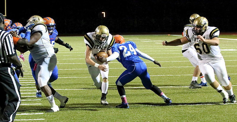 Image: Justin Wood(4) cuts in behind Darol Mayberry(58) and Kevin Roldan(60) for a much needed 10-yard touchdown in the third-quarter.