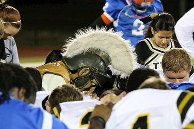 Image: The Gladiators are truly thankful as team mascot Noeli Garcia joins both teams in post-game prayer.