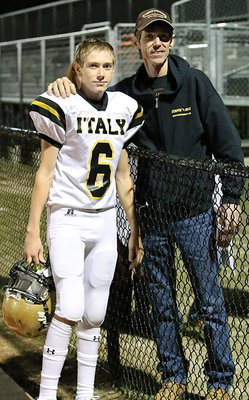 Image: Sophomore Clayton Miller(6) stands proud with his father after the game.