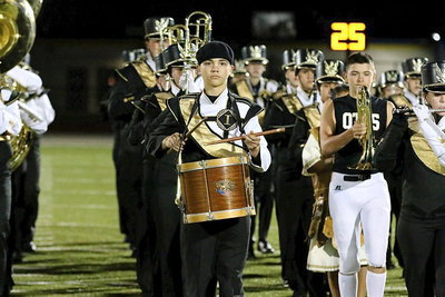 Image: Drummer Blake Brewer and Eli Garcia, on trumpet, lead the Gladiator Marching Band and Color Guard onto the field during halftime.