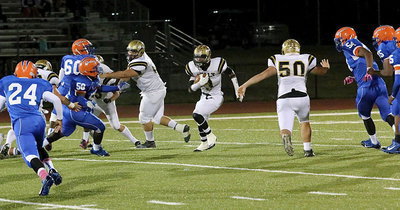Image: Trevon Robertson(3) finds running room behind Kevin Roldan(60) and Zain Byers(50) for a gain of 9 yards.