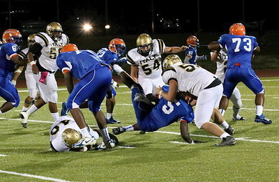 Image: Italy’s Coby Bland(40) trips up a Gator ball carrier trying to get out of the backfield with Zain Byers(50) and Bailey Walton(54) adding some finishing touches.