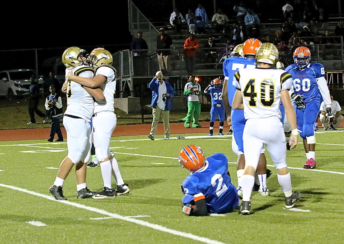 Image: Senior moment: Bailey Walton(54) offers a congratulatory hug to Zain Byers(50) after Byers sacks Gateway’s quarterback who was rolling out to pass.