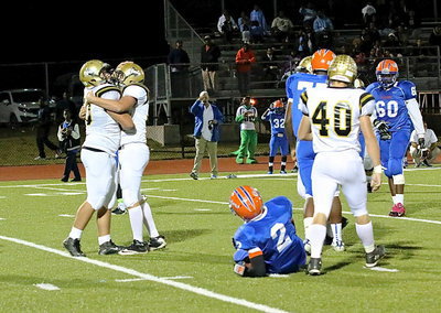 Image: Senior moment: Bailey Walton(54) offers a congratulatory hug to Zain Byers(50) after Byers sacks Gateway’s quarterback who was rolling out to pass.