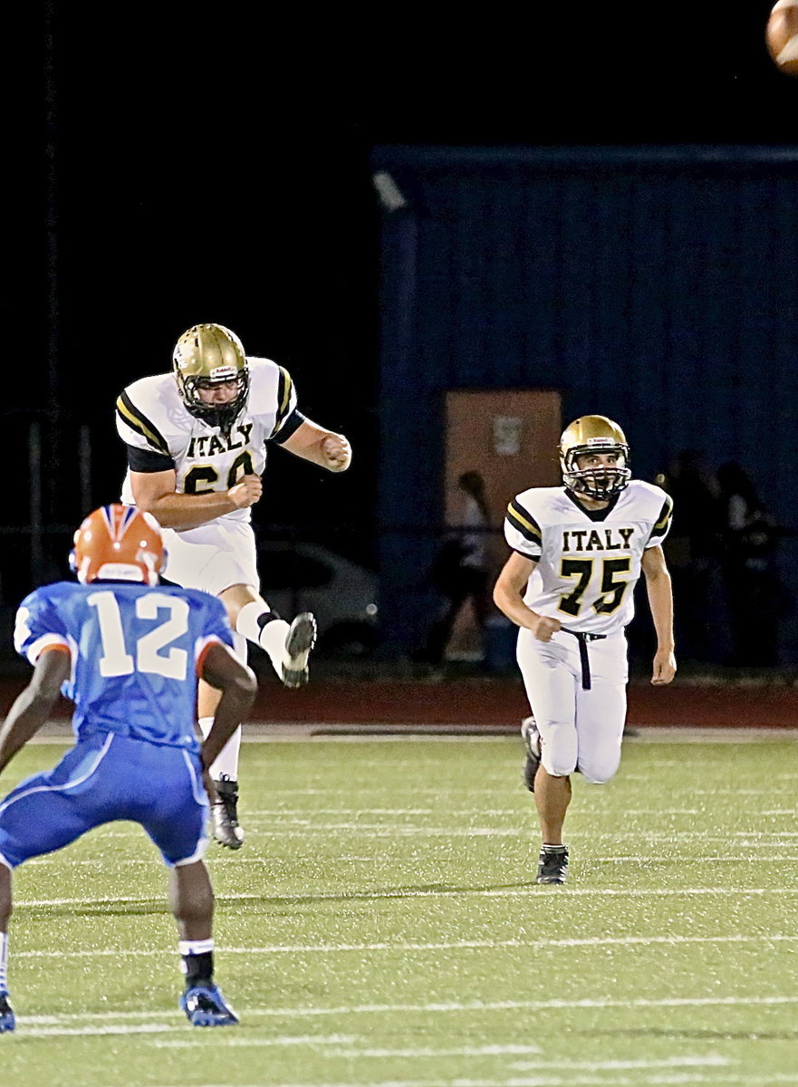 Image: Kevin Roldan(60) kicks off after an Italy touchdown as Cody Medrano(75) hurries to cover the return.