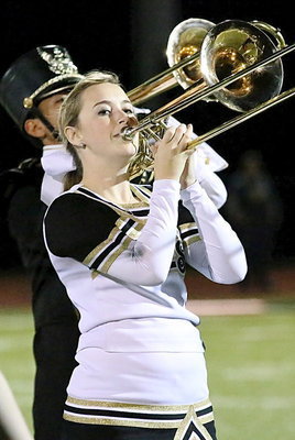 Image: Cheerleader Kelsey Nelson on trombone.