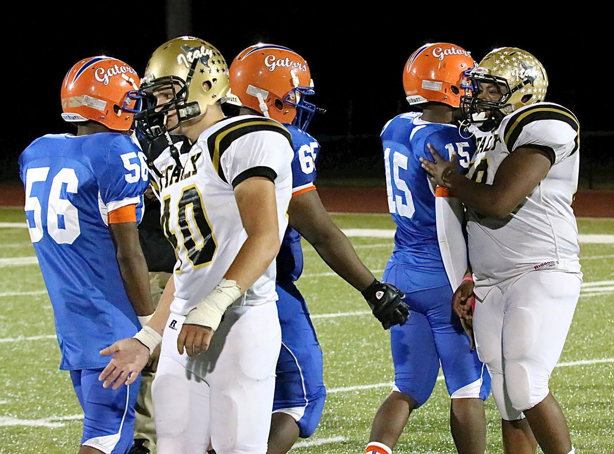 Image: Coby Bland(40) and Darol Mayberry(58) congratulate Gateway’s players on a hard fought game after the Gladiators rally to win 28-24 in the game’s final minute.