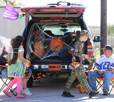 Image: The Hernandez family participates with their elaborately decorated trunk.