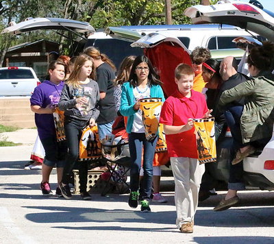 Image: Tanner Chambers leads his classmates from trunk to trunk.