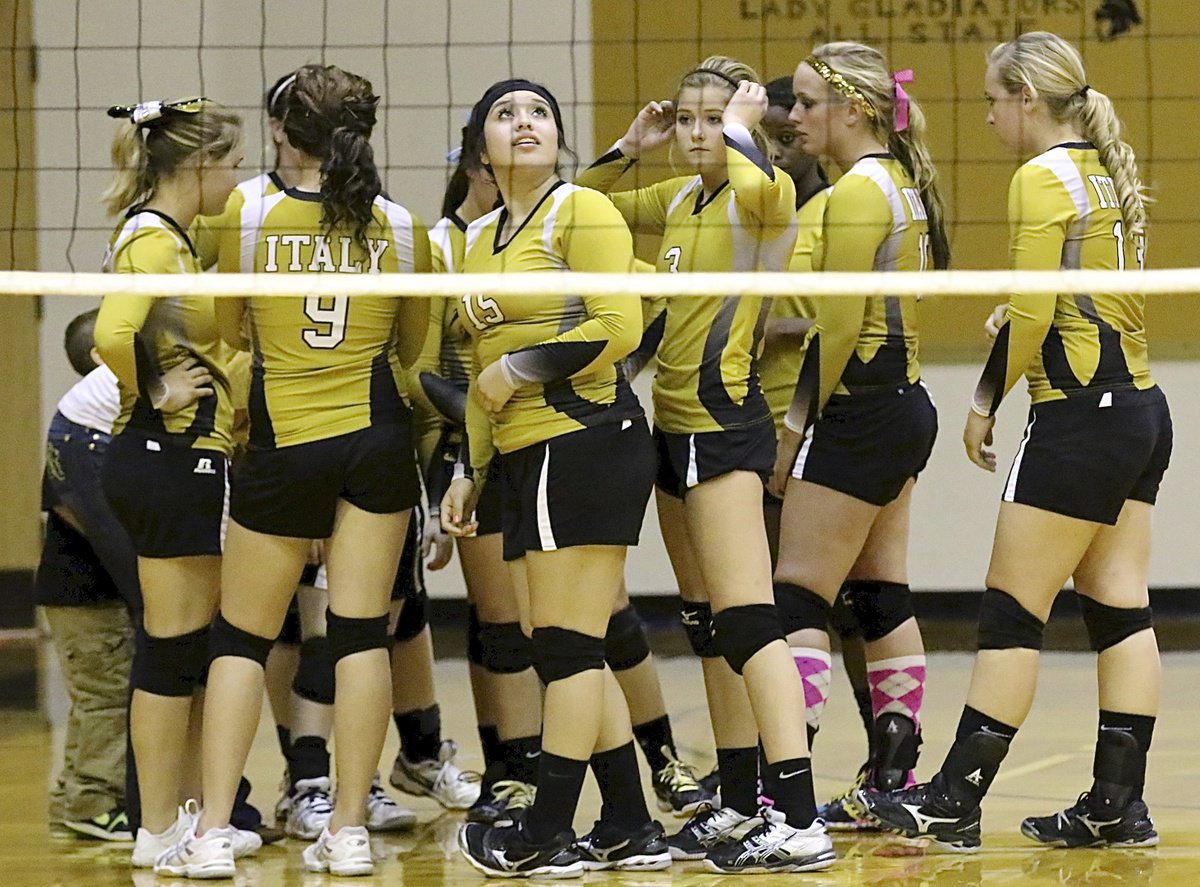 Image: Senior Monserrat Figueroa(15) checks the score as her team huddles up.