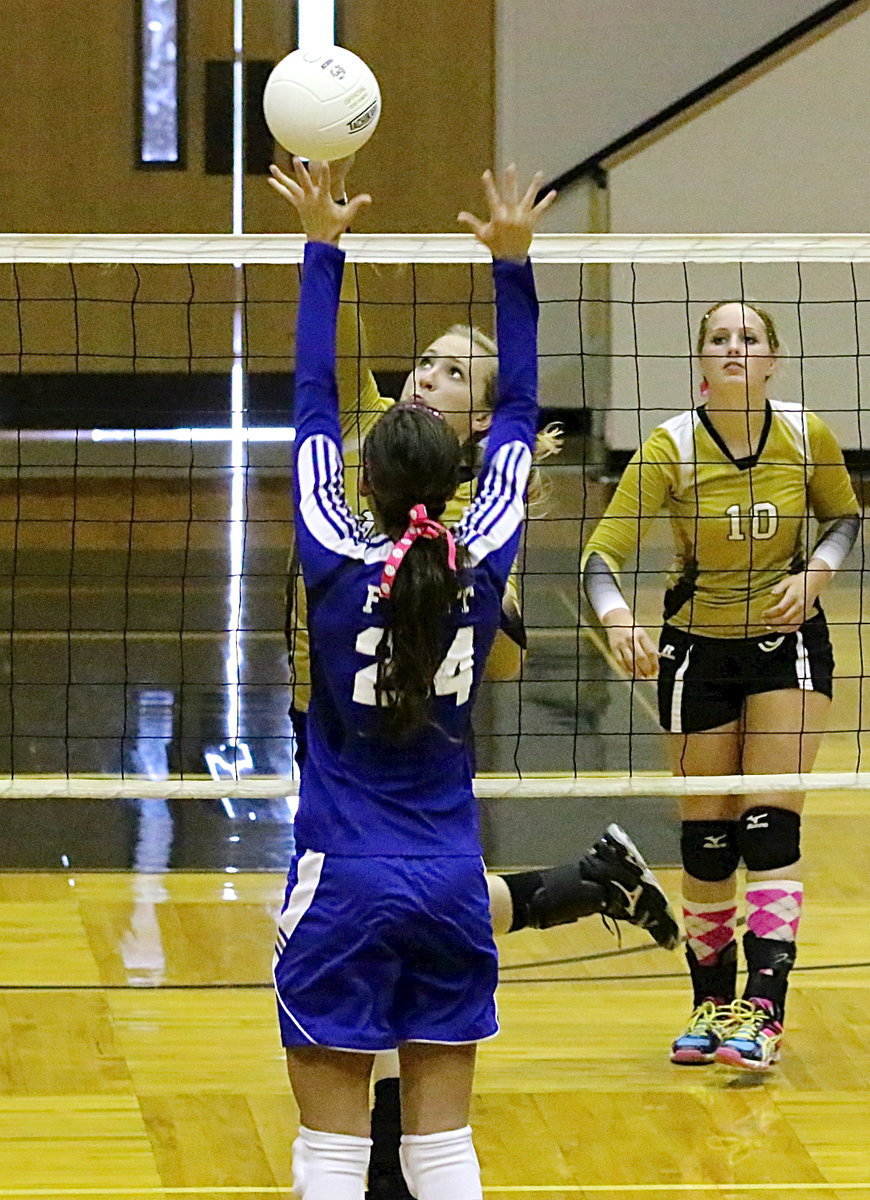 Image: Madison Washington(10) looks on as Jaclynn Lewis(15) scores over a Frost blocker.