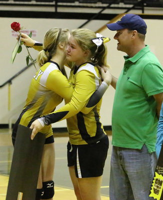 Image: Senior Lady Gladiator, Taylor Turner(14), is escorted by her teammate and younger sister, Halee Turner(3), and her father, Paul Cockerham.