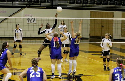 Image: Janae Robertson(5) makes a play against a a pair of Frost defenders.
