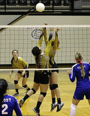 Image: Senior Monseratt Figueroa(15) and teammate Halee Turner(3) join forces at the net.