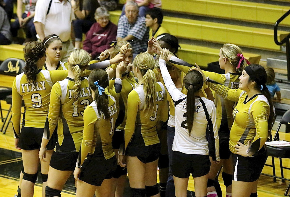 Image: Seniors Paige Westbrook(15), Taylor Turner(14) and Monserrat Figueroa(15) join their teammates in a team huddle.