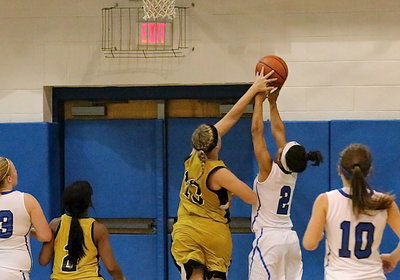 Image: Jaclynn Lewis(13) gets the block to foil a Blooming Grove fast break attempt.