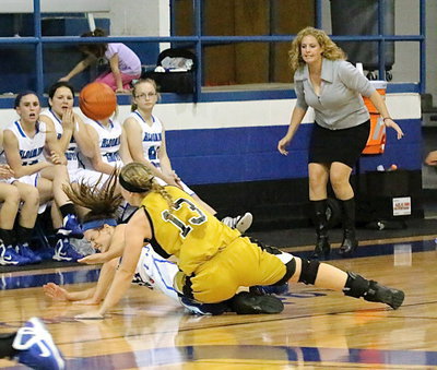 Image: Jaclynn Lewis(13) collides with a Blooming Grove player with both ladies going for the loose ball.