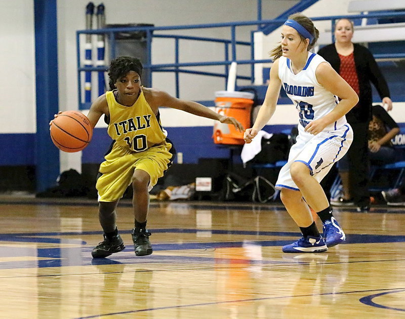 Image: Guard Kendra Copeland(10) maneuvers the ball past a Grove defender.