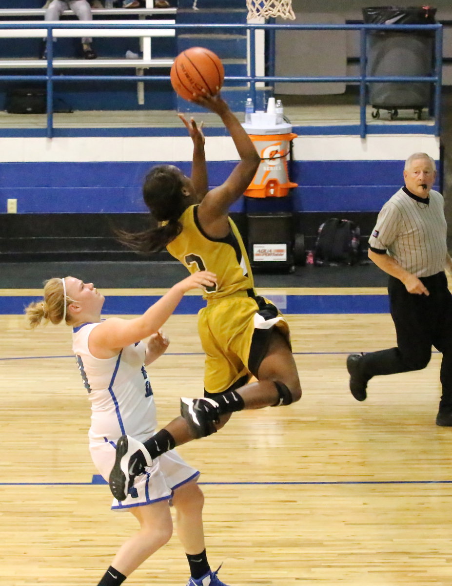 Image: Kortnei Johnson(3) draws a shooting foul against the Grove.