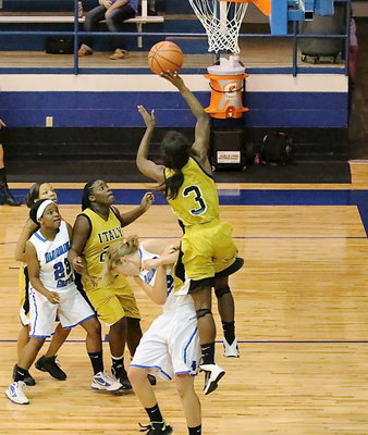 Image: Kortnei Johnson(3) is hard to stop as teammate Taleyia Wilson(22) moves in to rebound.