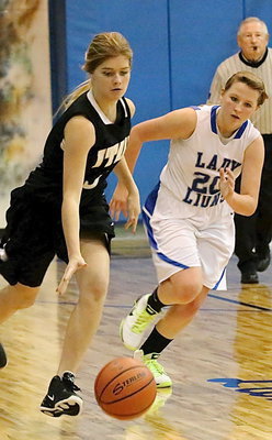 Image: JV Lady Gladiator Halee Turner(3) pushes the ball up the court.