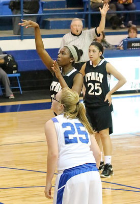 Image: Lizzy Garcia(25) looks on as teammate Janae Robertson(10) tries her hand at a free throw.