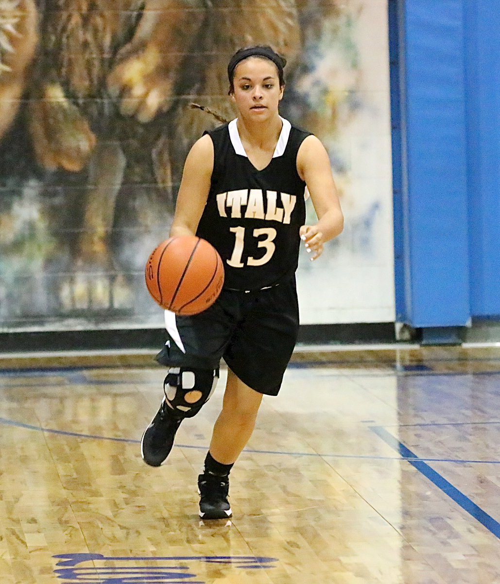 Image: Ashlyn Jacinto(13) dribbles the ball up the floor.