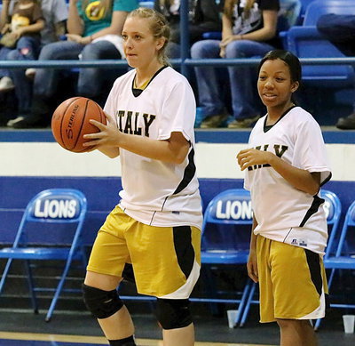 Image: Jaclynn Lewis and Ryisha Copeland  getting warmed up for their varsity game agains Blooming Grove.
