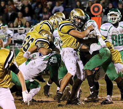Image: Senior offensive lineman Cody Medrano(75) and Kyle Fortenberry(66) man handle the Bobcat defensive front.