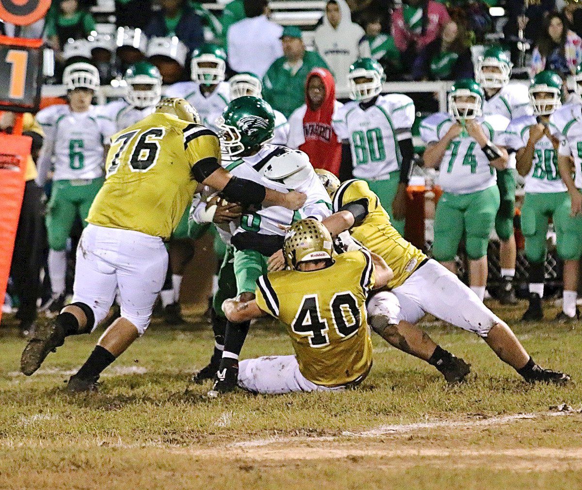 Image: Colin Newman(76), Coby Bland(40) and Zain Byers(50) combine for a stop in the Bobcat backfield. Newman, a junior, stated after the contest, “I had the defensive game of my life!”