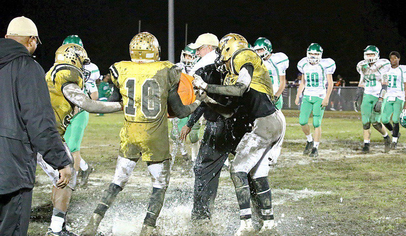 Image: Gladiator head coach Charles Tindol gets the ceremonial Gatorade bath from seniors Trevon Robertson, TaMarcus Sheppard and Darol Wayne Mayberry after Italy KOs Kerens 33-7 to win the championship outright with a 5-0 undefeated record in district.