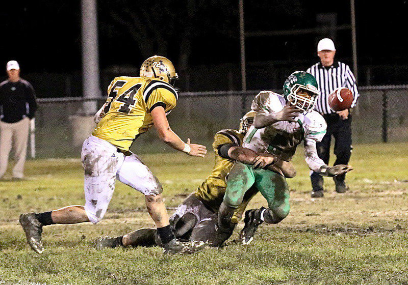 Image: End Zain Byers(50) causes the ball to pop out during this tackle for a loss as teammate Bailey Walton(54) goes after the ball.