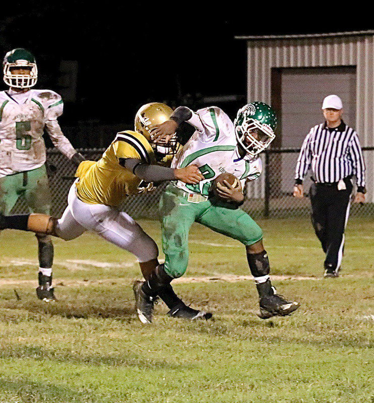 Image: JV Gladiator David De La Hoya(77) steps up and then rips down a Bobcat runner in the backfield.