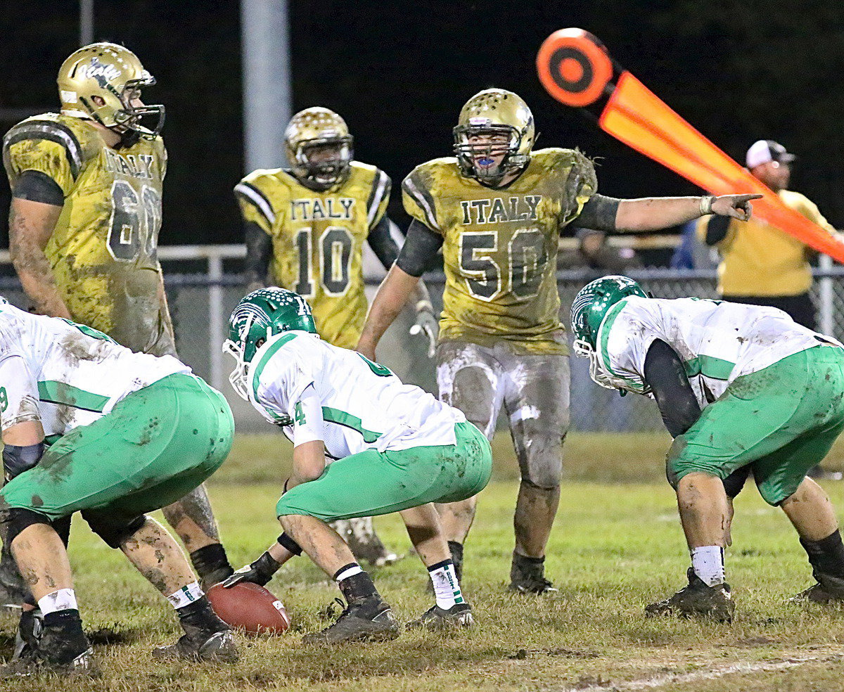 Image: With stuff growing off of him in the second-half, senior defensive end Zain Byers(50) alerts his team to a possible screen play which forces Kerens to call a timeout.