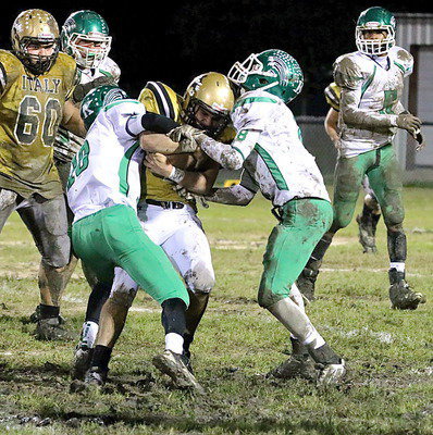 Image: Senior backup quarterback/running back Tyler Anderson(11) tries to fight off a pair of Bobcat tacklers.