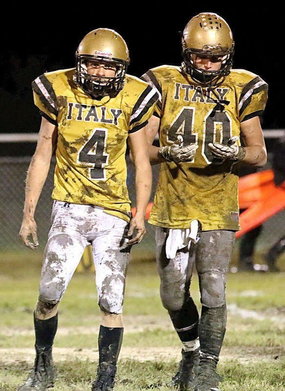 Image: Gladiators Justin Wood(4) and Coby Bland(40) make the most of a messy situation to help Italy earn another golden football.