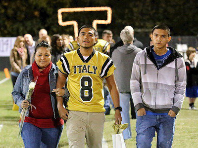 Image: Gladiator senior Reynaldo Salas, Jr.(8), is escorted by his mother Sonia Salas and brother Jonathan Salas.