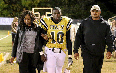 Image: Gladiator senior TaMarcus Sheppard(10) is escorted by his mother Lois Campbell and his father/coach Bobby Campbell.
