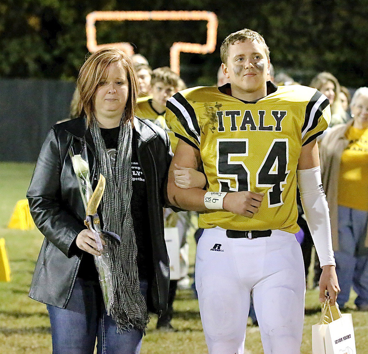 Image: Gladiator senior Bailey Walton(54) is escorted by his proud mother Michele Richards Walton.