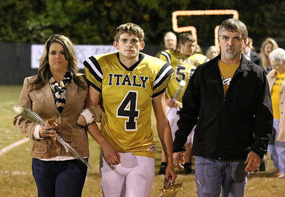 Image: Gladiator senior Justin Wood(4) is escorted by his mother Tina Long and his father Gary Wood who taught Justin everything he knows about football.