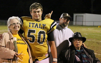 Image: Gladiator senior Zain “Zilla” Byers(50) is escorted by his grandmother Ann Byers, his grandfather Ervin “Doc” Byers and his hero and father Barry “Beebop” Byers. OK, I may have gone a little overboard with the hero thing:)