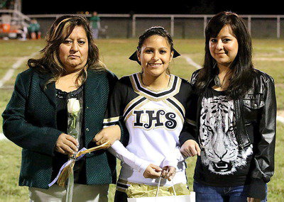 Image: Gladiator senior cheerleader Jessica Garcia is escorted by her mother Gloria Quintero and her sister.