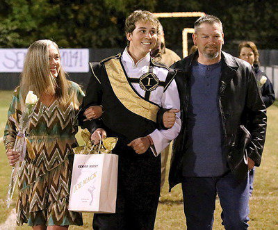 Image: Gladiator Regiment Band senior JoeMack Pitts is escorted by his mother Vicki Coffman and his father Johnny Pitts.
