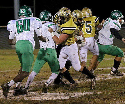 Image: Offensive linemen Kyle Fortenberry(66) and Cody Medrano(75) open a hole for Coby Bland(40).