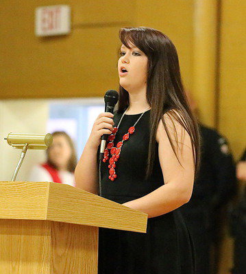 Image: Senior Paige Westbrook addresses the audience and asks the question, “What is a veteran?”