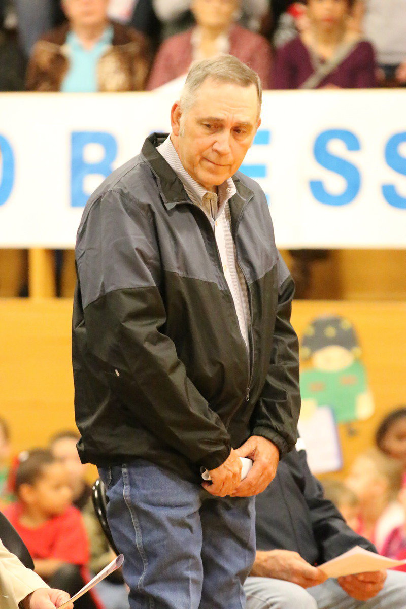 Image: Veteran Larry Norcross stands during the playing of service songs by the Gladiator Regiment Band.